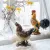 Rustic rooster from A Lot Decoration in window along with matching hen and spring decoration