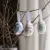 Hanging Easter eggs on a branch in blue, pink and green from A Lot Decoration