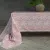 Large tablecloth Sonia in pink with a pattern from Fondaco laid on a table.
