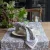 The Dante cloth napkin in a blue pattern together with the runner from Fondaco in the same pattern set on a table.