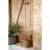 Interior detail with a nautical feel; doorstop in braided hemp standing by a rustic door.
