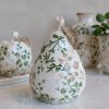 Chic Antique hand-painted ceramic decorative pear from the Grasse series, standing on a light marble counter.