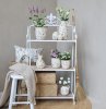 Rustic-style shelf in antique white with three wooden shelves from Chic Antique, decorated with flowers and interior decor items.