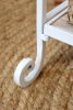 Close-up of an ornate foot on the antique-white shelf from Chic Antique.