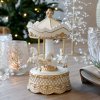 Chic Antique nostalgic Noël music box in antique cream and gold, featuring carousel horses on a set Christmas table.