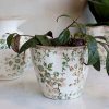 Small pot from the Grasse series, featuring a green floral pattern, from Chic Antique, placed on a white table.