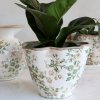 The larger pot from the Grasse series, featuring a green floral pattern from Chic Antique, on a white table.