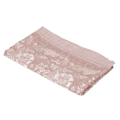 Wipeable patterned textile oilcloth Sonia from Fondaco in pink and off-white on an outdoor garden table, dimensions 140x250 cm.