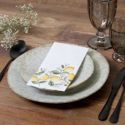 Table setting on a rustic dining table with lemon napkins and matching decor details.