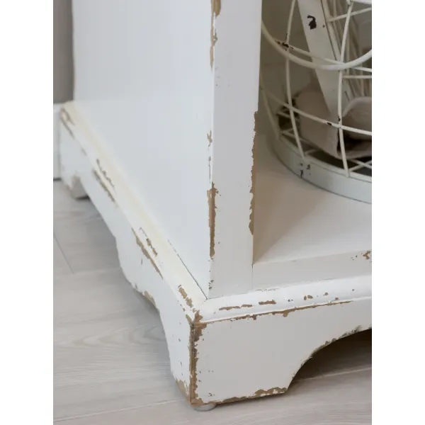 Close-up of the base of the Jacqueline bookcase in antique cream from Chic Antique.
