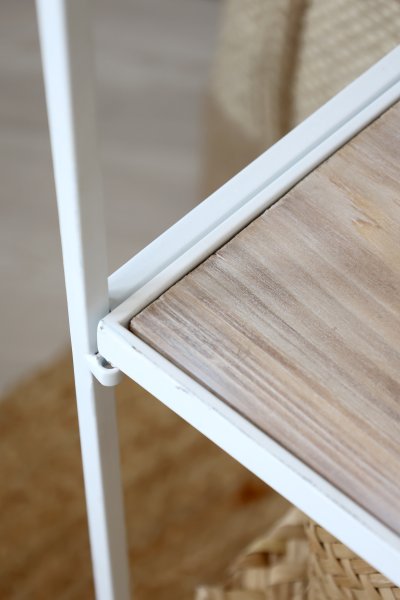 A detail shot of the antique-white shelf from Chic Antique, where natural wood meets white metal.
