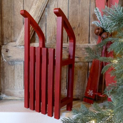 Red decorative sledge against a door from Chic Antique