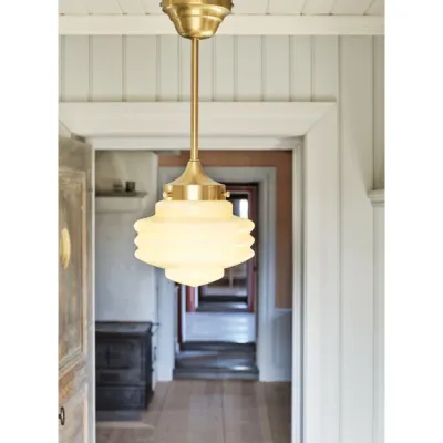 Valter ceiling lamp with rod, brass and opal white hanging in a hallway - Strömshaga
